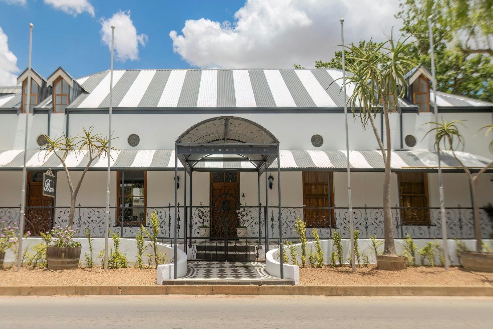 The Tin Roof guesthouse exterior with striped corrugated roof